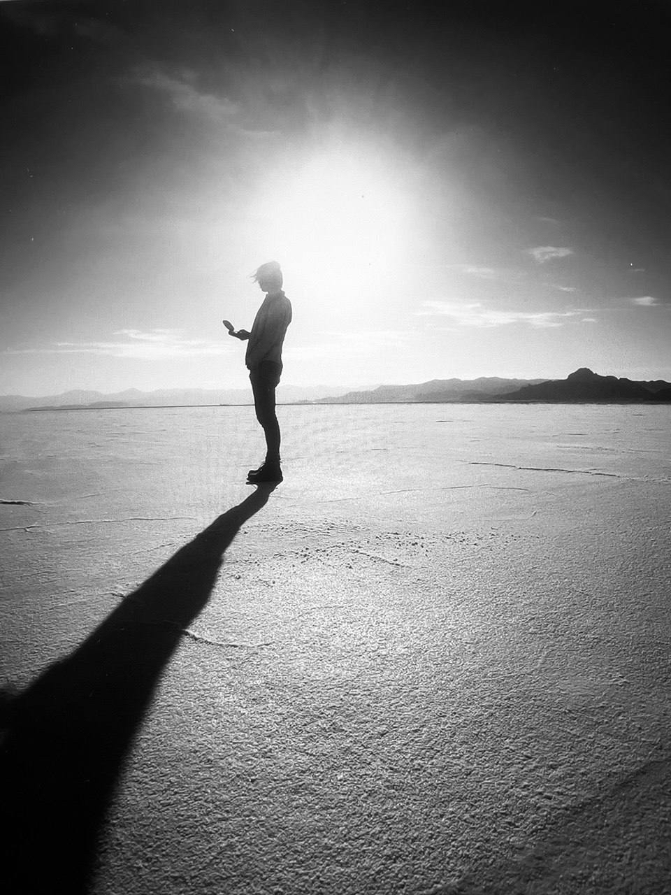 Silhouette standing on a bright salt flat
